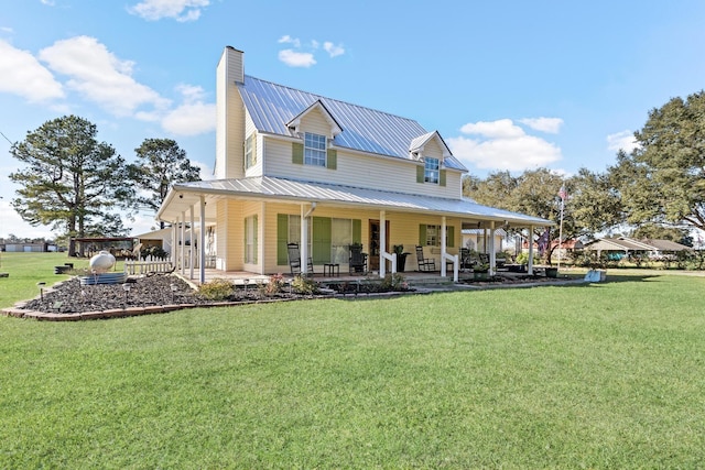 rear view of house featuring a lawn