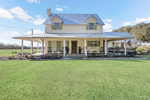 back of property with a lawn and a porch