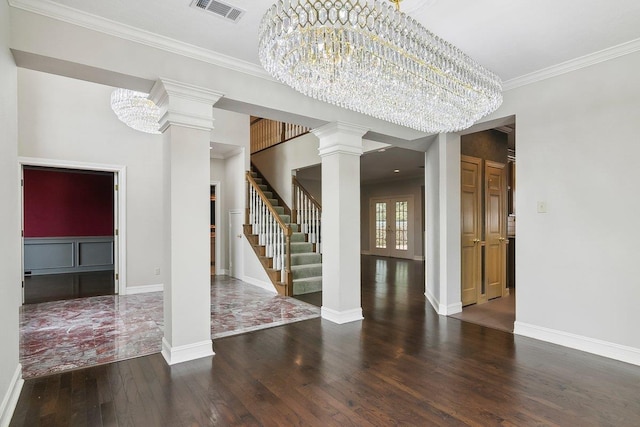 interior space with ornate columns, crown molding, dark wood-type flooring, and a notable chandelier