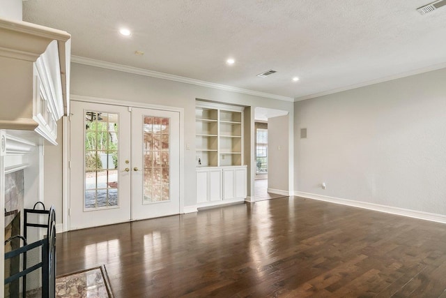 unfurnished living room with ornamental molding, a healthy amount of sunlight, built in features, and french doors