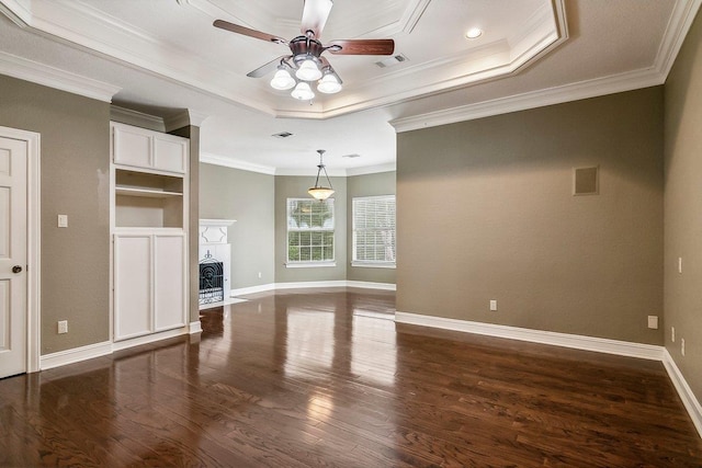 unfurnished living room with crown molding, dark wood-type flooring, a raised ceiling, and ceiling fan