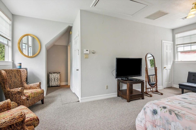 bedroom featuring multiple windows and light colored carpet