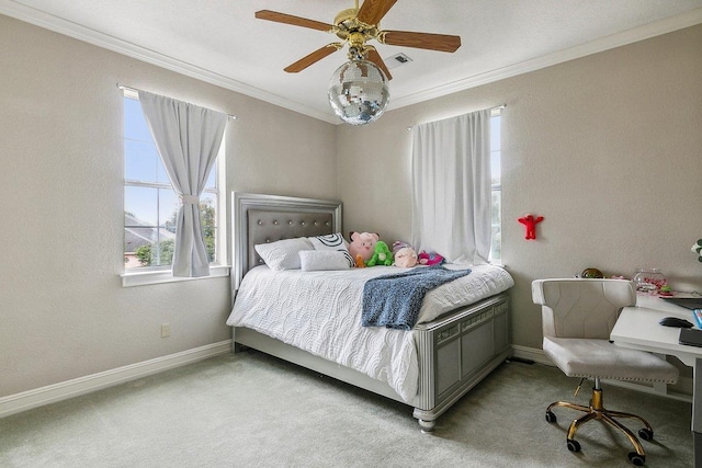 carpeted bedroom featuring ornamental molding and ceiling fan