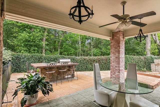 view of patio with exterior bar and ceiling fan