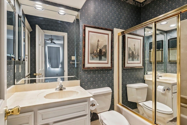 full bathroom with bath / shower combo with glass door, vanity, and toilet