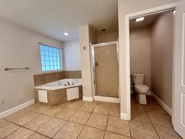 bathroom featuring tile patterned floors, toilet, and shower with separate bathtub