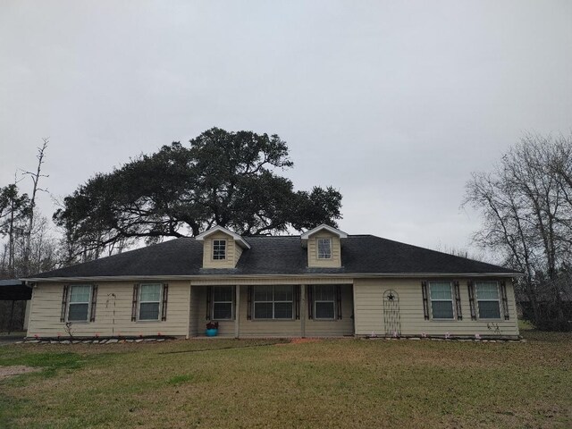 view of front of house with a front lawn and a carport