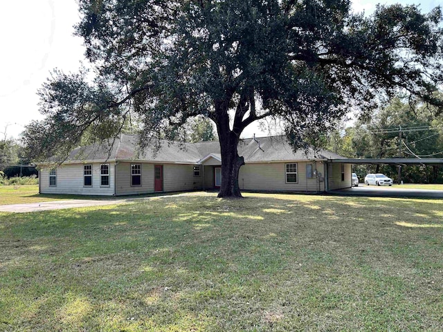 ranch-style home with a front yard and a carport