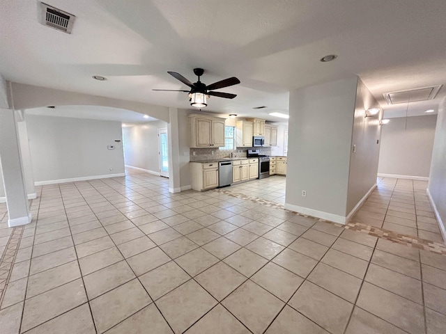 unfurnished living room with ceiling fan and light tile patterned floors