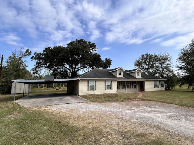 view of front of house with a front yard and a storage shed