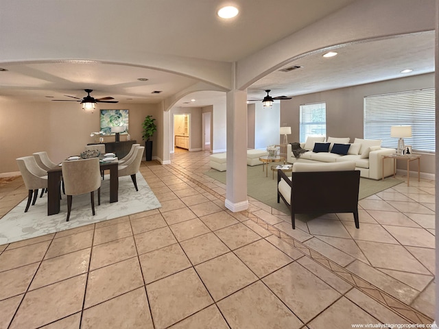 tiled living room with ceiling fan