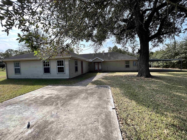 single story home featuring a front yard and a carport