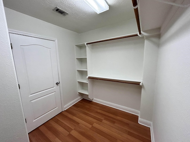 walk in closet featuring wood-type flooring