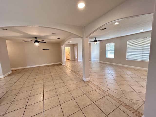 unfurnished room with ceiling fan and light tile patterned floors