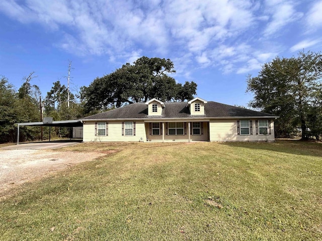 view of front of property with a front lawn and a carport