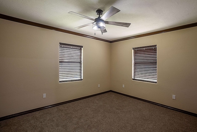 empty room with carpet flooring, ceiling fan, and ornamental molding