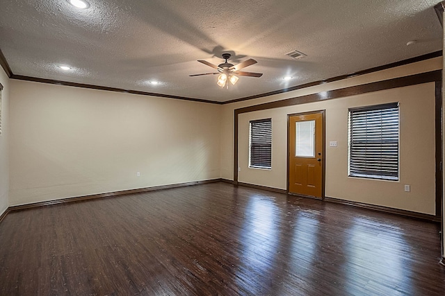 empty room featuring a textured ceiling, dark hardwood / wood-style floors, and ceiling fan