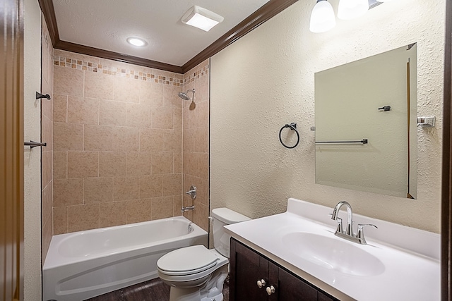 full bathroom featuring vanity, toilet, tiled shower / bath, and ornamental molding