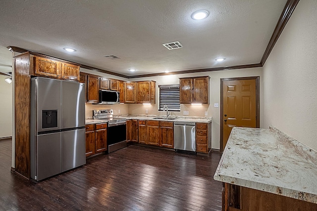 kitchen featuring sink, dark wood-type flooring, stainless steel appliances, crown molding, and a textured ceiling