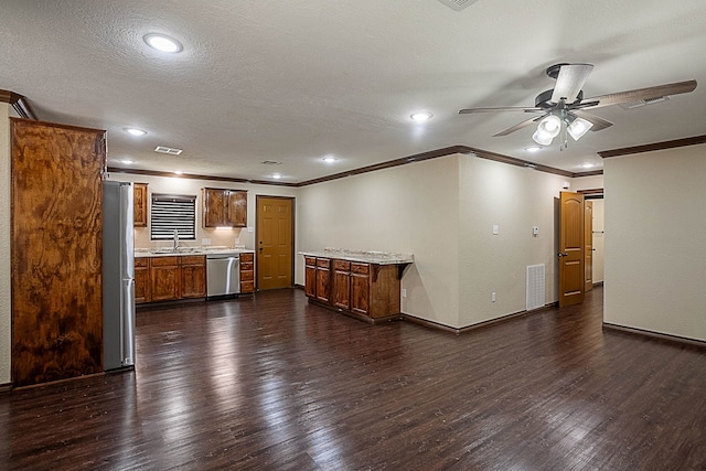 unfurnished living room featuring ceiling fan, sink, dark wood-type flooring, and ornamental molding