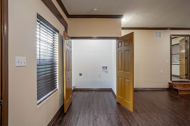 corridor featuring a textured ceiling, dark wood-type flooring, and ornamental molding