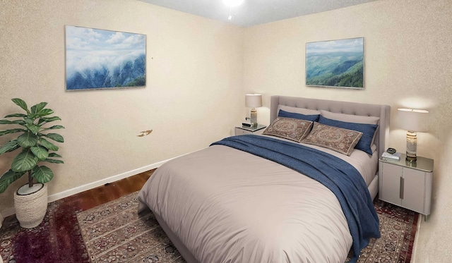 bedroom with baseboards and wood finished floors