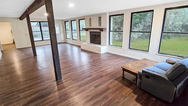 living area with baseboards, dark wood-style floors, a fireplace, beam ceiling, and recessed lighting