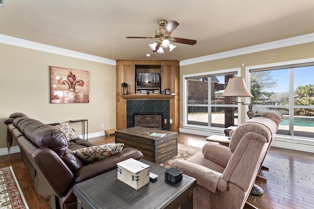 302 Waterwood Dr, Orange, TX 77630 - living room featuring crown molding, dark wood finished floors, a ceiling fan, baseboards, and a large fireplace