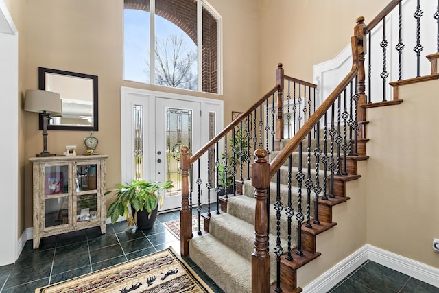 302 Waterwood Dr, Orange, TX 77630 - foyer entrance featuring baseboards, a high ceiling, stairway, and dark tile patterned flooring