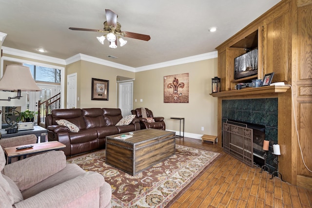 302 Waterwood Dr, Orange, TX 77630 - living room featuring ceiling fan, a tiled fireplace, wood finished floors, crown molding, and baseboards