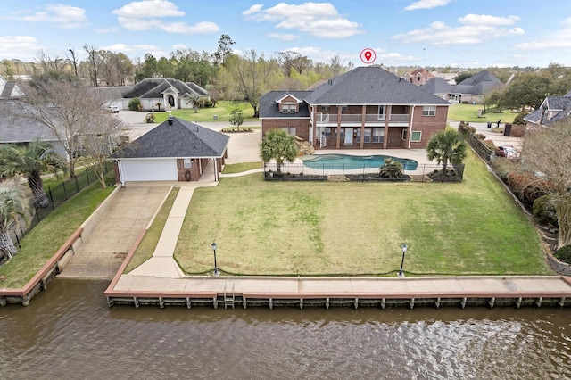 302 Waterwood Dr, Orange, TX 77630 - back of house with a balcony, a water view, concrete driveway, and a residential view