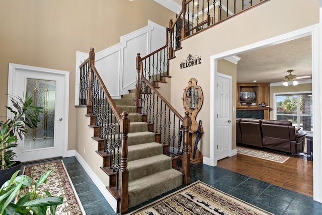302 Waterwood Dr, Orange, TX 77630 - entryway featuring a high ceiling, stairway, ceiling fan, baseboards, and ornamental molding