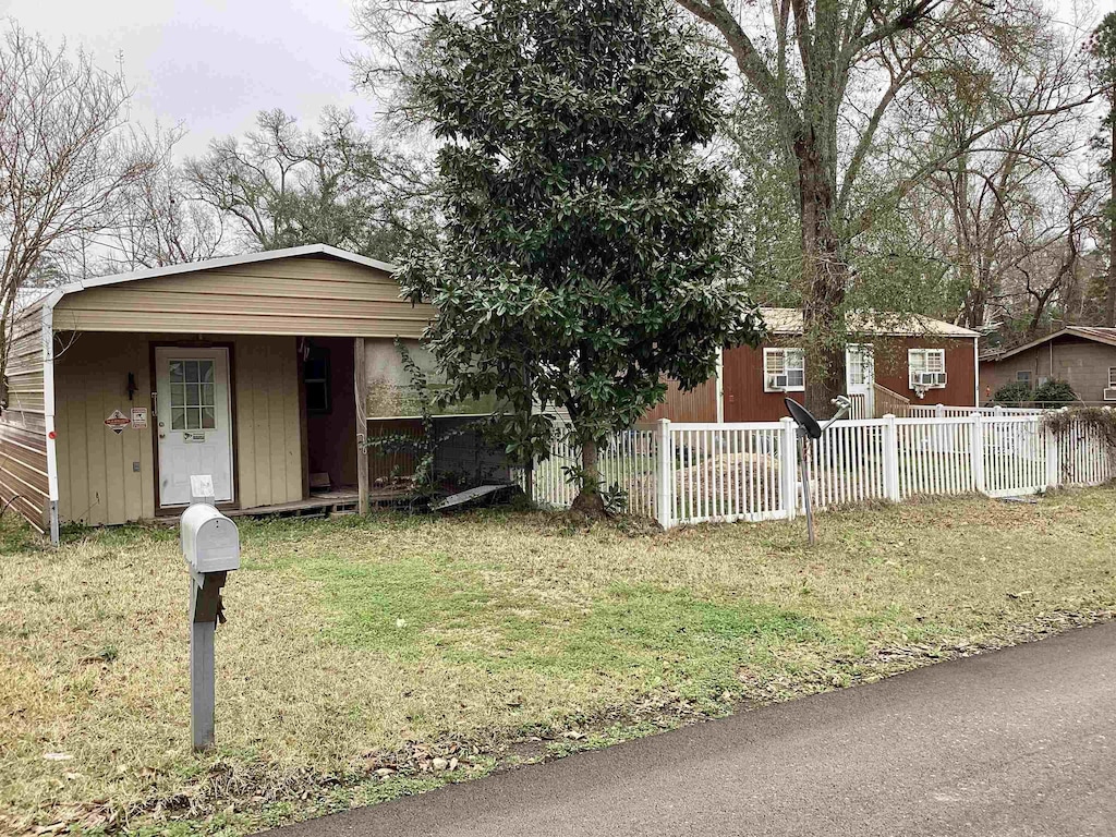 ranch-style home featuring fence and a front yard