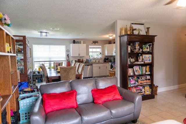 tiled living room featuring a textured ceiling