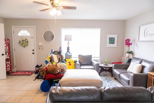 living room featuring light tile patterned floors and ceiling fan