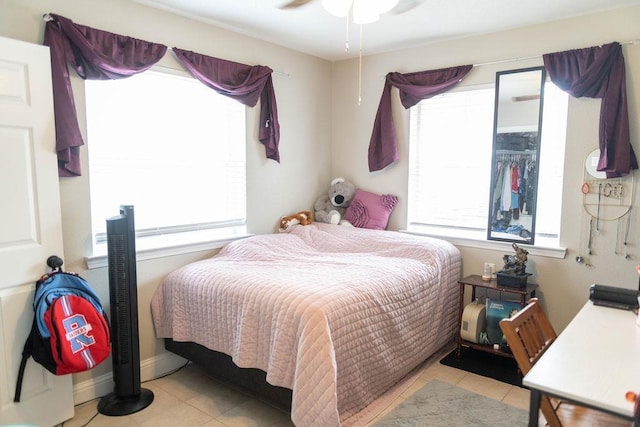 tiled bedroom featuring ceiling fan