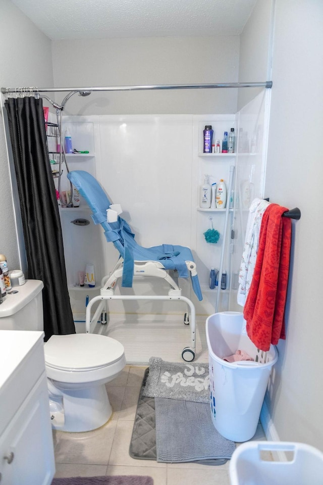 bathroom featuring tile patterned flooring, vanity, a shower with shower curtain, and toilet