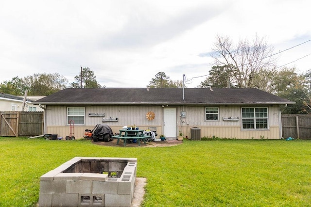 back of house featuring a yard and central AC unit