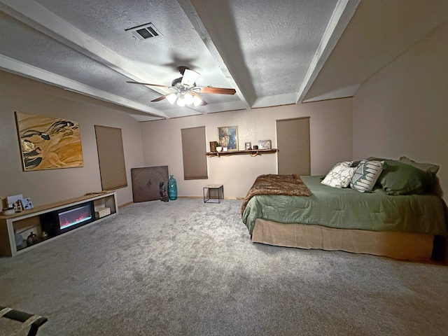 330 Hillcrest Dr, Lumberton, TX 77659 - carpeted bedroom featuring a textured ceiling, a ceiling fan, and beam ceiling