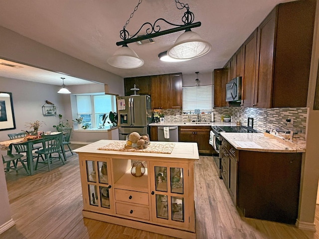 330 Hillcrest Dr, Lumberton, TX 77659 - kitchen with stainless steel appliances, a sink, light countertops, decorative backsplash, and dark brown cabinets