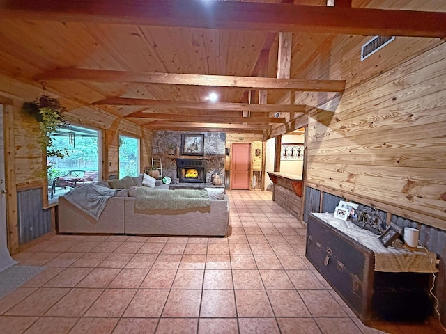 330 Hillcrest Dr, Lumberton, TX 77659 - unfurnished living room featuring wood walls, wooden ceiling with exposed beams, a fireplace, and light tile patterned floors