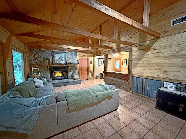 330 Hillcrest Dr, Lumberton, TX 77659 - living room featuring wood walls, wood ceiling, light tile patterned flooring, and a stone fireplace