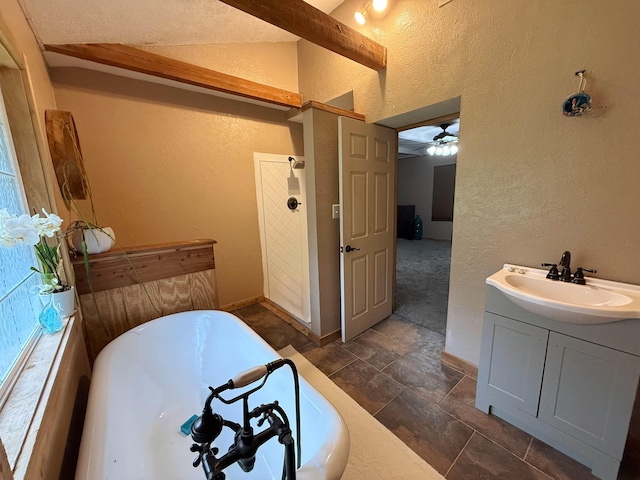 330 Hillcrest Dr, Lumberton, TX 77659 - full bath featuring a textured wall, a freestanding bath, vanity, ceiling fan, and baseboards