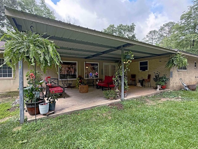 330 Hillcrest Dr, Lumberton, TX 77659 - back of property featuring a patio area, a lawn, and brick siding