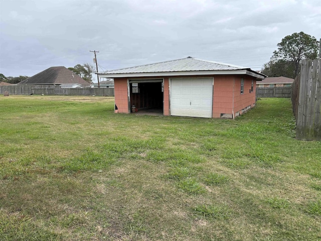 exterior space with an outdoor structure, a garage, and a yard