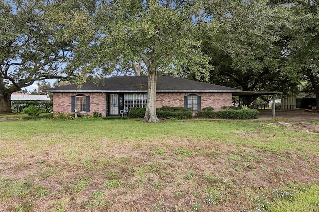 ranch-style house with a front yard and a carport