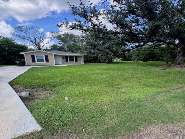 exterior space featuring driveway and a front lawn