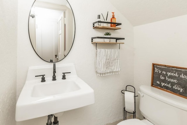 bathroom featuring sink, a textured ceiling, and toilet