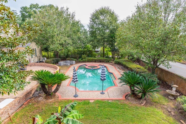 view of swimming pool featuring an in ground hot tub