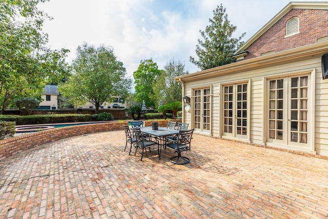 view of patio featuring a pool with hot tub